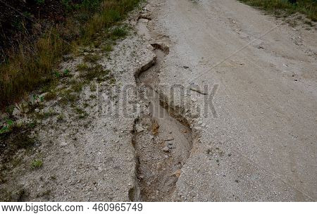 Erosion Grooves After Rains In A Dirt Road. Deep Ground After A Storm. Lack Of Drainage Will Cause S