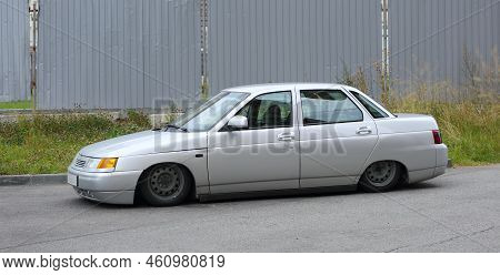 A Gray Understated Car Is Parked Near A Gray Fence, Soyuzny Prospekt, St. Petersburg, Russia, Septem