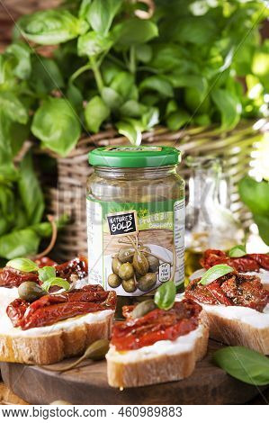 Bruschetta With Sun-dried Tomatoes, Cheese, Basil And Capers. Traditional Appetizer For Aperitivo In