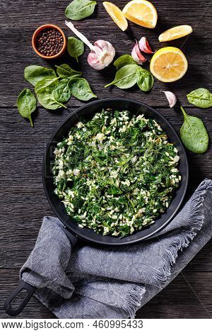 Spanakorizo, Greek Spinach And Rice Pilaf With Lemon, Dill, Spring Onion On A Pan On Dark Wooden Tab