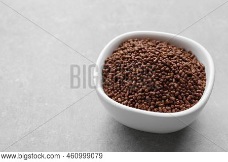 Buckwheat Tea Granules In Bowl On Light Grey Table. Space For Text
