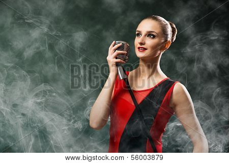 beautiful blonde woman singer with a microphone