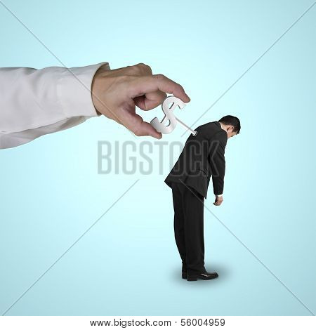 Hand winding money symbol winder on businessman's back