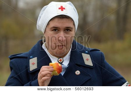 KIEV, UKRAINE -NOV 3 An unidentified members of Red Star history club wears historical German Red Cross (DRK) uniform during historical reenactment of WWII, , November 3, 2013 Kiev, Ukraine 