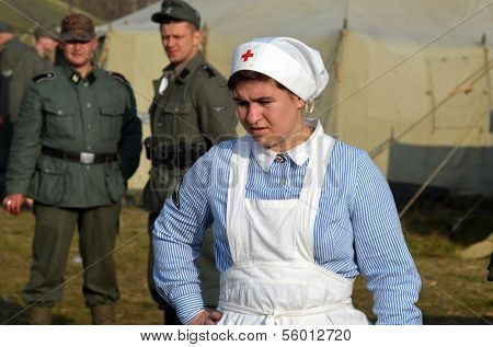 KIEV, UKRAINE -NOV 3 An unidentified members of Red Star history club wears historical German Red Cross (DRK) uniform during historical reenactment of WWII, , November 3, 2013 Kiev, Ukraine 