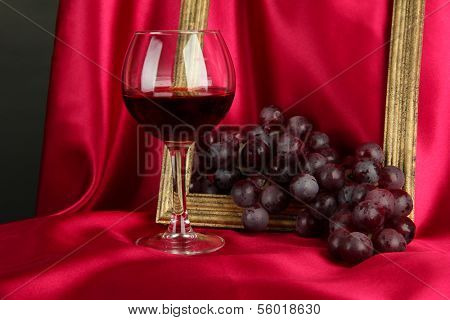composition of frame,wine and grapes on bright background