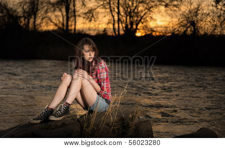 Girl Sitting On A River Rock