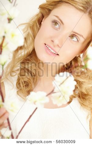 Young woman looking at sprong flowers