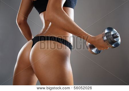 Athletic young woman doing a fitness workout with weights