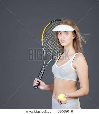 Attractive girl tennis player with racket and tennis ball