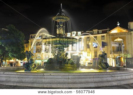 Night-lit fountain in Rossio Square, Lisbon, Portugal