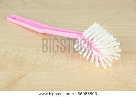 Toilet brush on wooden background