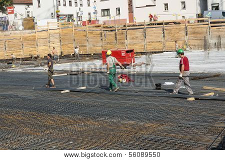 Workers Do The Steel Bars Construction At The Building Site