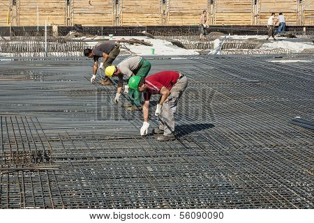 Workers Do The Steel Bars Construction At The Building Site