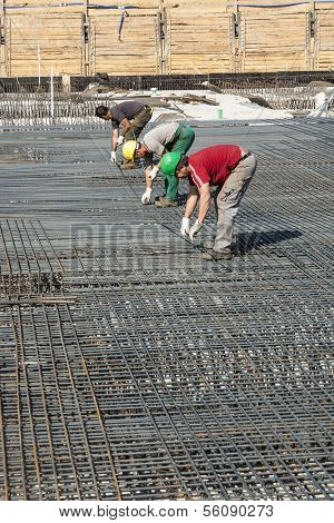 Workers Do The Steel Bars Construction At The Building Site