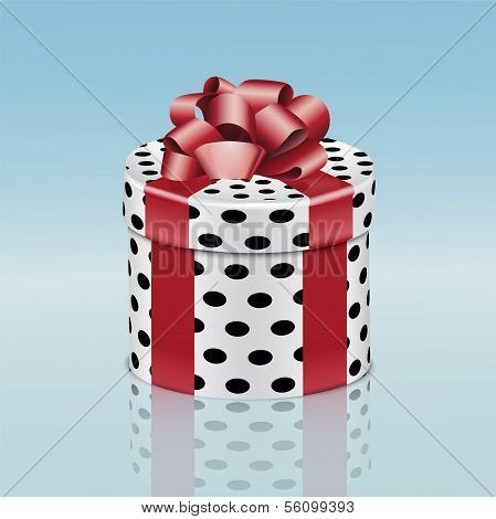 Round gift box with red ribbon