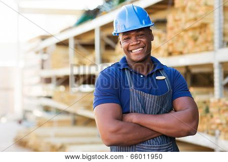 handsome african male warehouse worker with arms crossed
