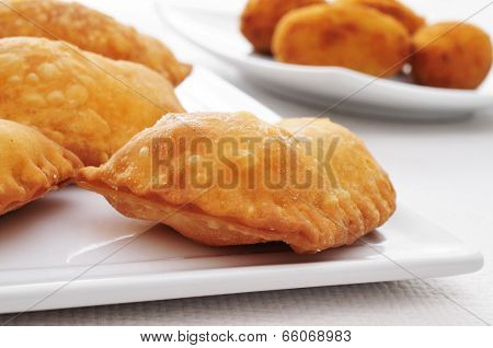 closeup of a plate with some spanish empanadillas, small meat or tuna pies, served as tapas