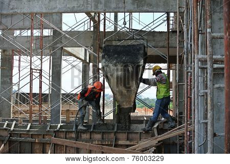Group of construction workers casting beam