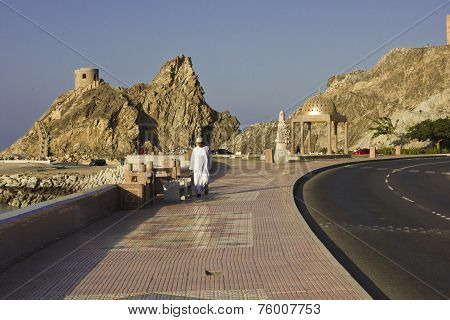 A Man walking on Muscat Promenade.