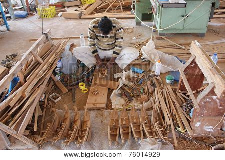 Man At Work Building A Boat