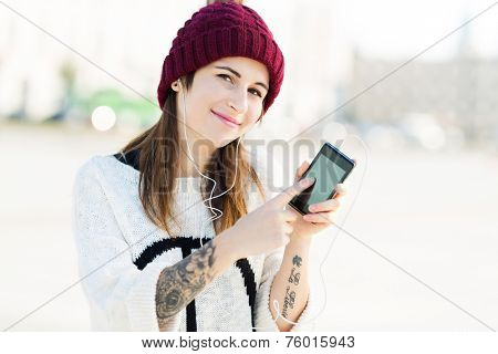 Girl listening to music on smartphone 