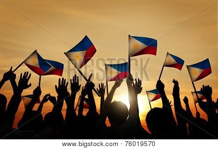 Group of People Waving Filipino Flags in Back Lit
