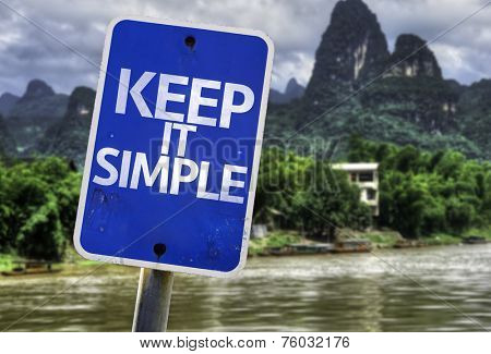 Keep It Simple sign with a forest background