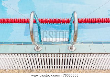 The Metallic Ladder Closes With Red Marked Lanes Of Swimming Pool.