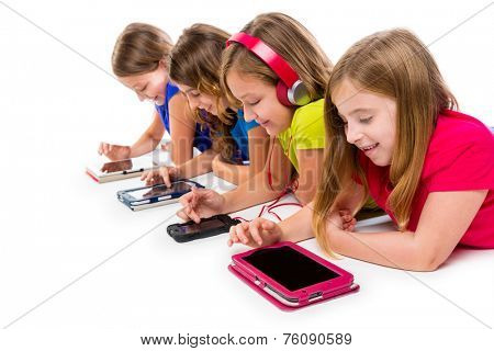 sisters cousins kid girls with tech tablets and smartphones in a row lying on white background