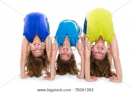 twin kid sisters girls friends playing as flexible contortionist happy on white background
