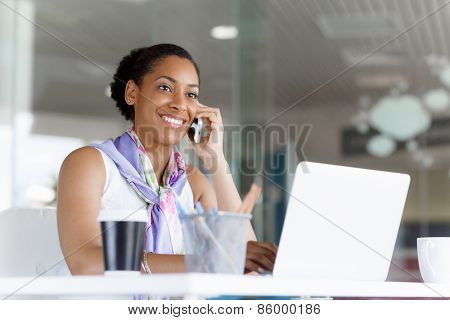 Beautifiul young businesswoman talking over phone