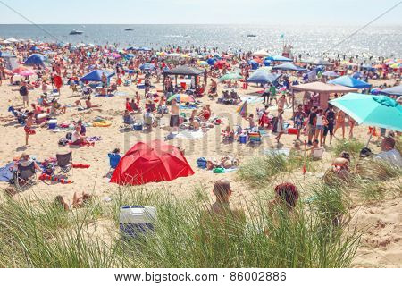 Beach scene on a busy summer day with blurred out people