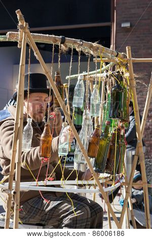 Helsinki,finland-march 29: The Street Musician Plays On Empty Bottles Helsinki,