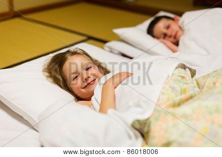 Kids sleeping on futons at traditional Japanese style room