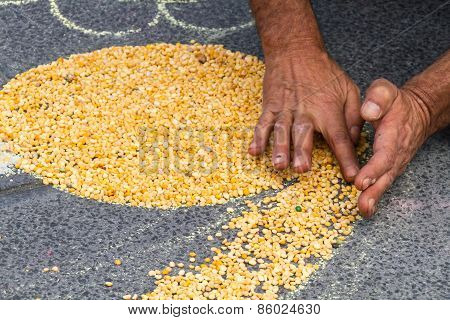 Hands making a yellow shape on the floor