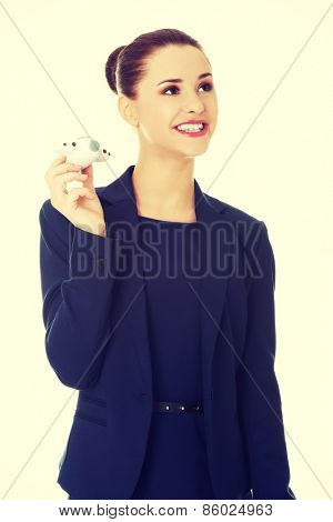 Young businesswoman with plane toy in hand