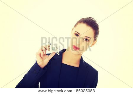 Young businesswoman with plane toy in hand
