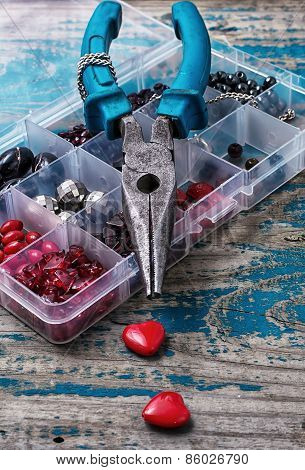 box of beads for needlework on wooden table