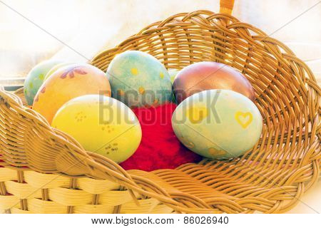 Easter and quail eggs in a wicker basket with Orchid