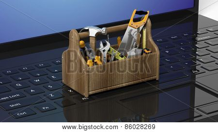 Toolkit with various tools on laptops keyboard