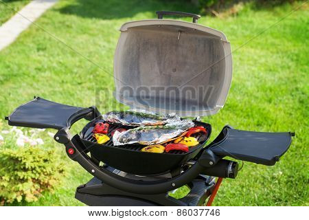 Fresh dorado fish and bell pepper grill cooking outdoors