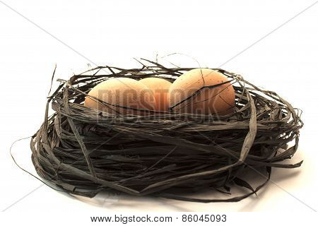 Three Brown Egg In A Nest