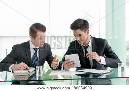 Two Businessman Using Tablet In Meeting