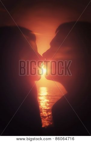 Silhouettes couple kissing at sunset