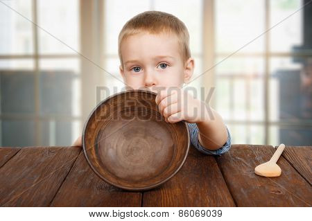 Cute Blonde Boy Shows Empty Plate