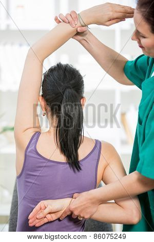 Chiropractor massage the female patient spine and back