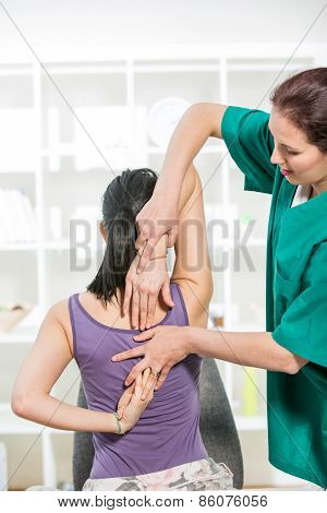 Chiropractor massage the female patient spine and back