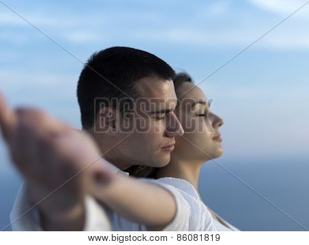 happy young romantic couple have fun relax smile at modern home outdoor terace balcony terace