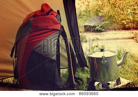 Orange backback and kettle in the tent